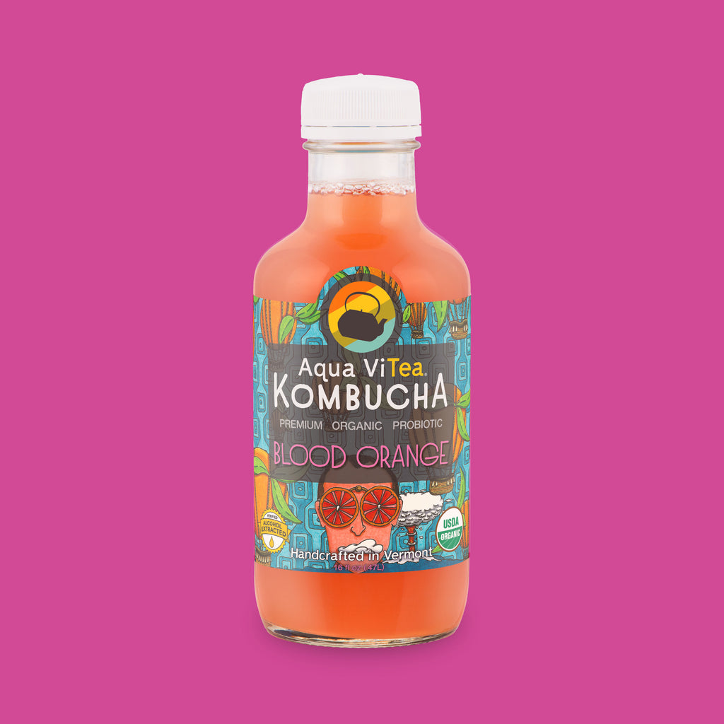 Blood orange kombucha bottle on a pink background