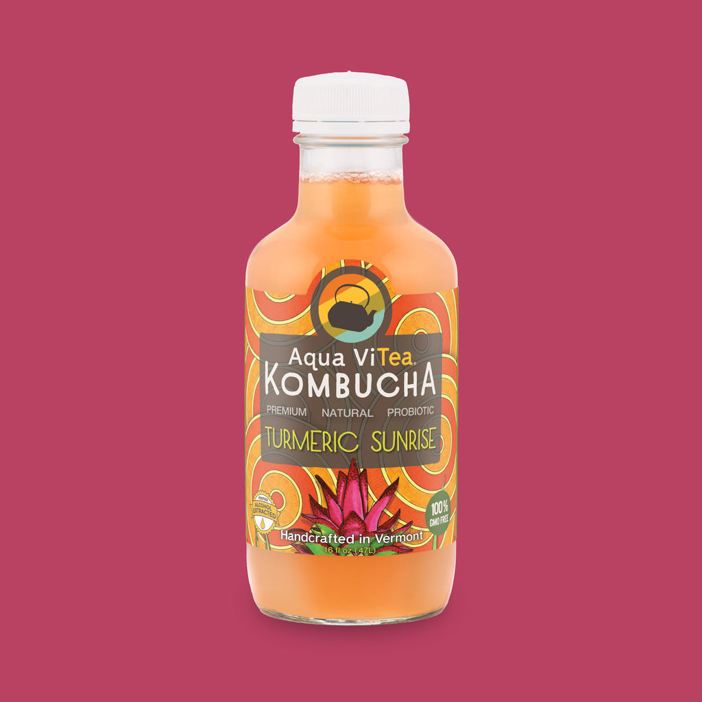 Turmeric Sunrise kombucha bottle on magenta background
